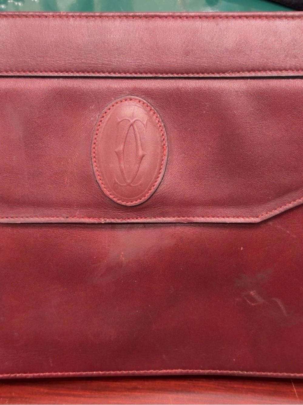 Cartier Burgundy Leather Flap Clutch with Embossed Logo